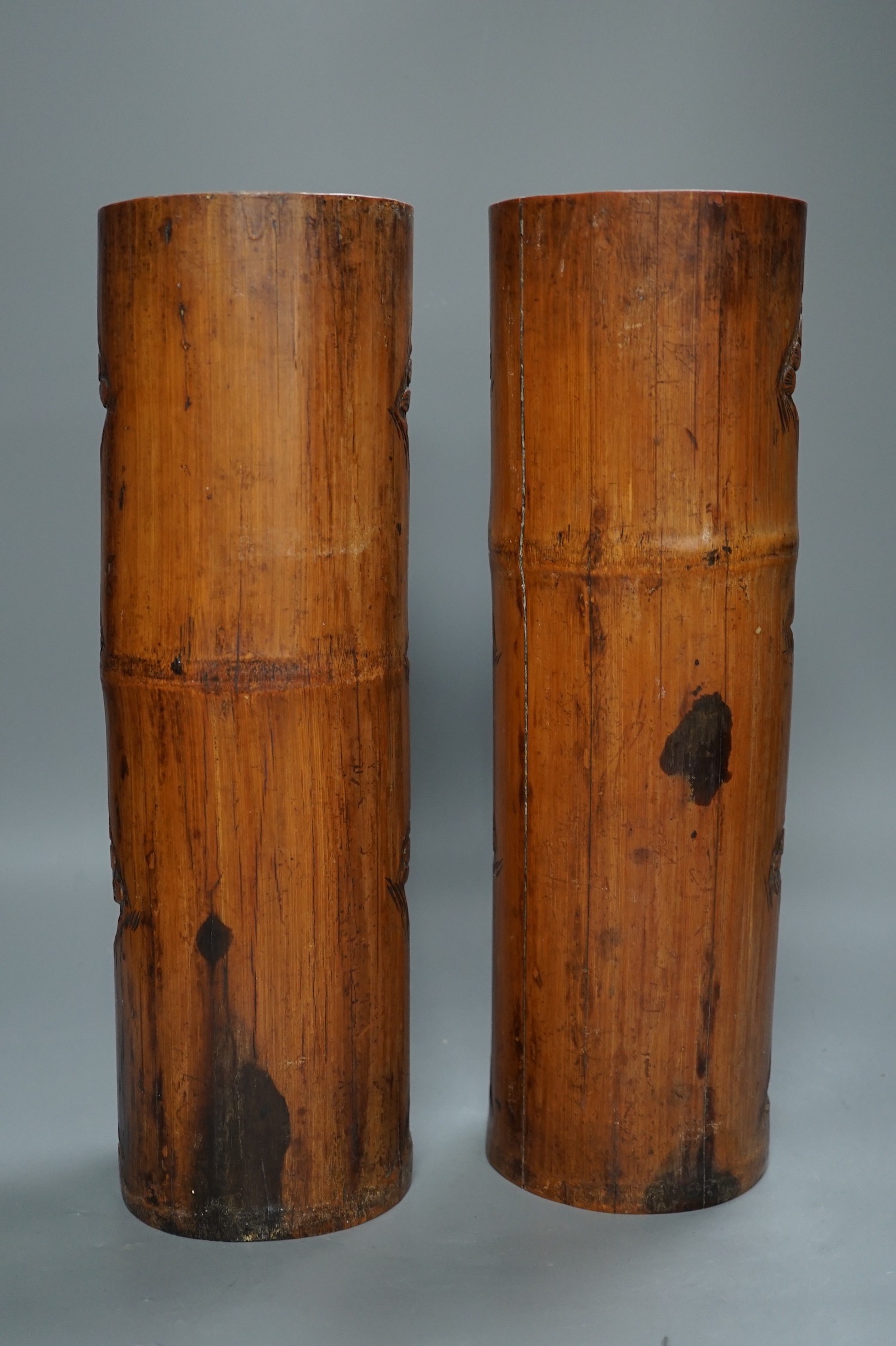 A pair of Chinese carved bamboo brush pots, 35 cms high